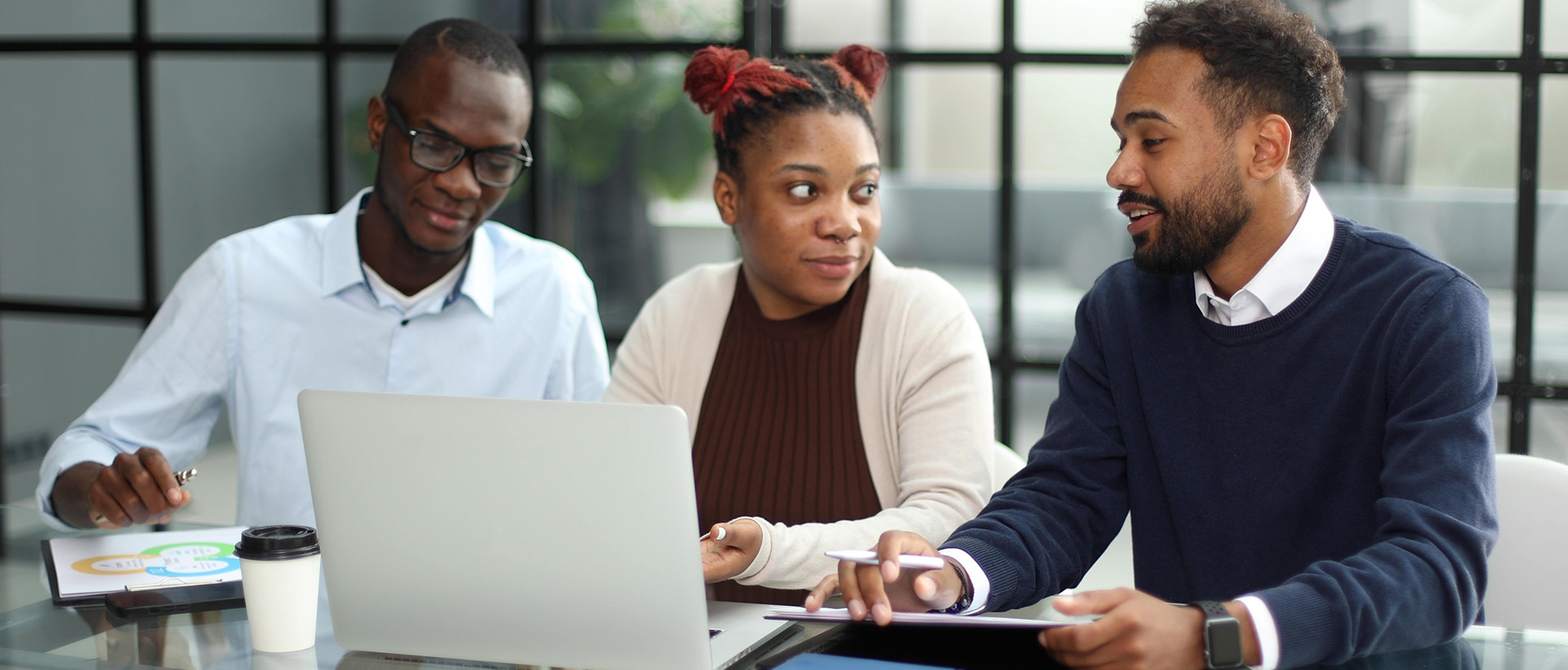 3Sixty Africa team members reviewing campaign work together at a desk